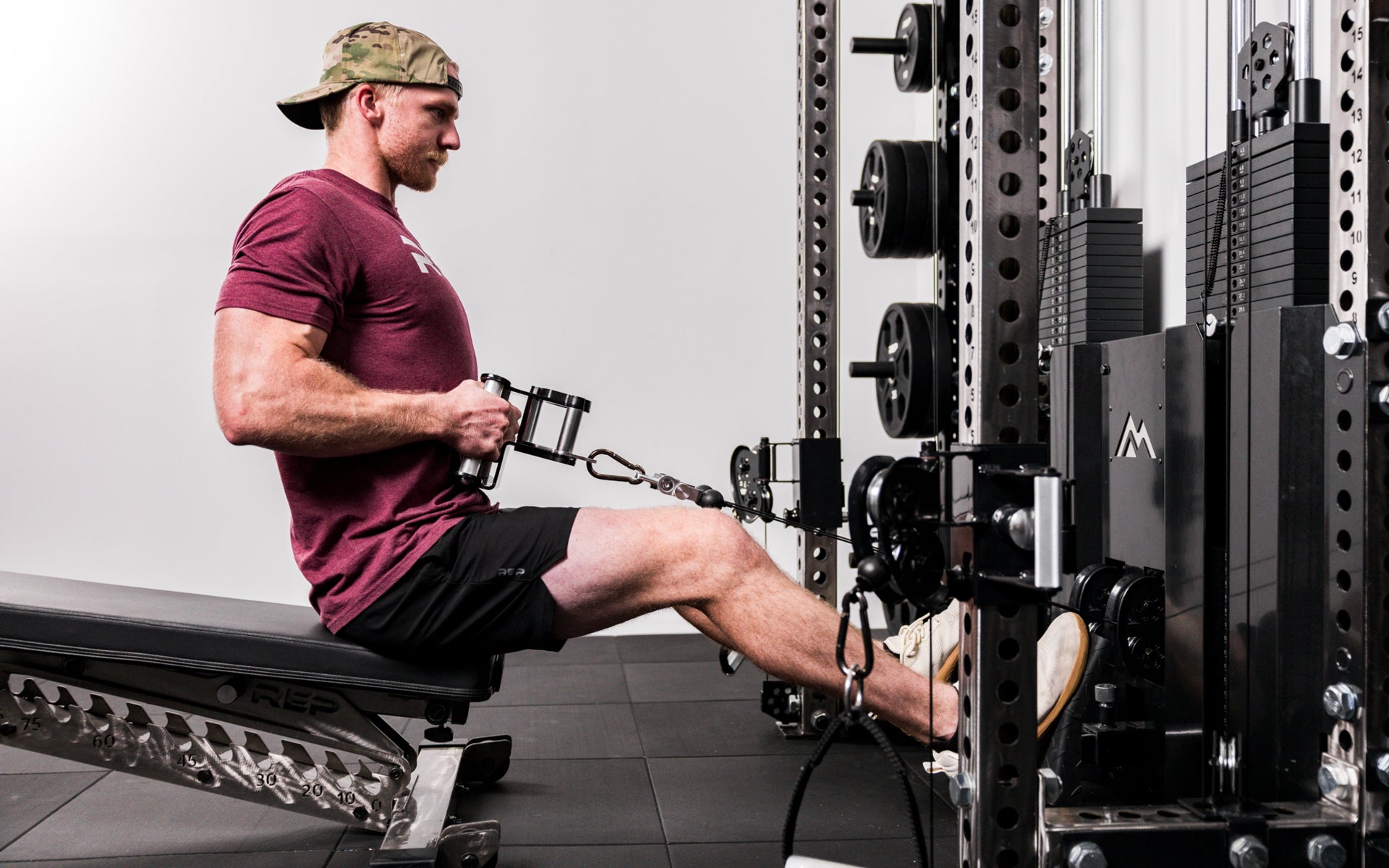 Athlete performing seated low rows with a REP® x Kleva Built® Angled Atlas™ Close-Grip Cable and Landmine Attachment