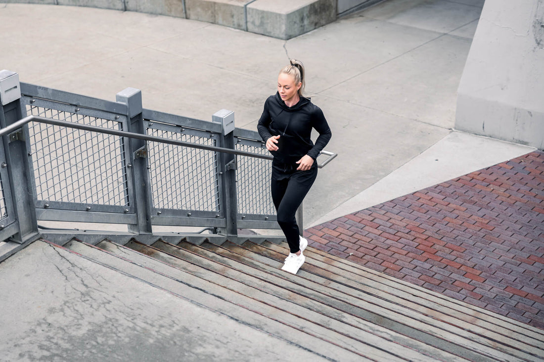 Athlete runs up a staircase in REP apparel.