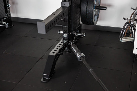 Front Foot Extension Pair 2.0 on power rack in gym setting with tile flooring