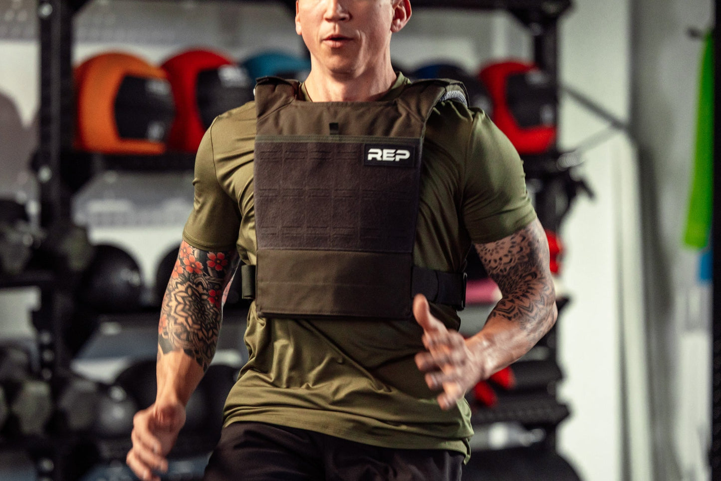 Athlete wearing the olive Strata Weight Vest running